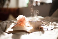 hojicha on a bed and next to a flower